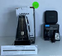 Linrax mechanical metronome in front of original box with owner's manual, all in good condition with slight box wear.