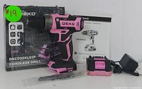 Photo showing DEKO pink cordless drill, battery, charger, instruction manual, and original box.