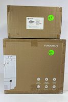 Two sealed cardboard boxes: one large with Furoomate branding for self-cleaning cat litter box and one smaller labeled Cat Litter Ramp