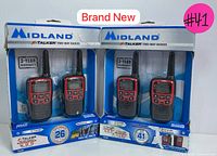 Photo showing two Midland X-Talker two-way radio sets in original sealed packaging, one with 26-mile range and 22 channels, the other with 41 channels and weather alert features.