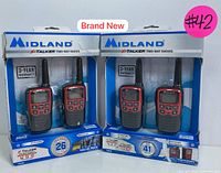 Photo of the two boxed Midland X-Talker two-way radio sets showing packaging, branding, and warranty information