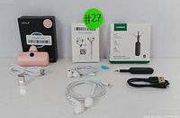 Lot arranged on white surface showing all included items with packaging and cables visible