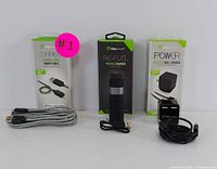 All three items together: fabric charging cable, portable charger, and wall charger with their cables.