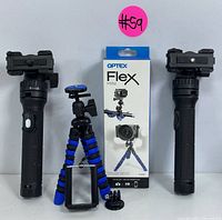Photo showing two black handheld tripods with quick-mount adapters and the flexible mini tripod with blue and black legs alongside its packaging.