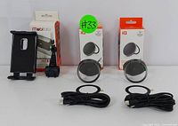 Overview of the lot showing two iQ wireless chargers with cables and one Mobimoto device mount.