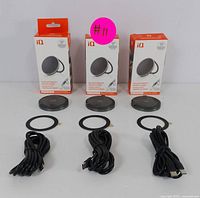 Three brand-name magnetic wireless chargers with built-in kickstands, each with a USB cable and mounting ring, displayed alongside their boxes.