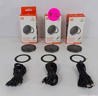 Three boxed iQ brand magnetic wireless chargers with kickstands, each displayed with the charger, circular adhesive magnetic ring, and a USB charging cable.