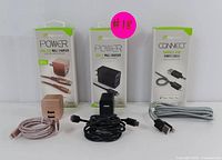 Photo showing three boxes of DigiGlow branded charging accessories with two fabric cables and two wall adapters out of the box.