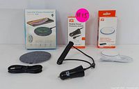 Whole set of charging accessories showing wireless charging pad, in-car charger, power adapter, and cables.
