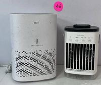 Front view of the TaoTronics air purifier and compact cooling fan side by side.