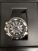 Front view of watch face and rotating bezel seated on foam pillow