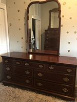 Front and mirror view of brown Hickory wooden dresser with brass handles