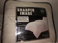 Sharpen Image King size down alternative comforter in packaging showing features and dimensions.