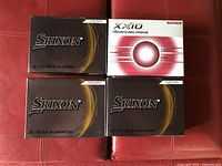 Four boxes of golf balls: three Srixon Z-Star and one XXIO Rebound Drive box, showing front packaging design.