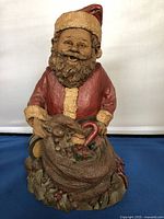 Front view of resin Santa Claus figurine showing detailed facial features, beard, and red suit.