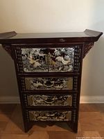 Full front view of cabinet showing overall shape, color, and inlay design