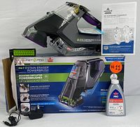 Full set including cordless Bissell Pet Stain Eraser PowerBrush cleaner, original box, Bissell PRO OXY cleaning formula, power adapter, and user manual.