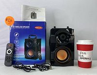 Speaker with packaging box, remote control, USB cable, user manual, and size reference cup.