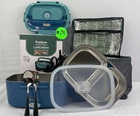 Photo showing the blue electric lunchbox with stainless steel trays, clear lids, insulated carrying bag, utensils, adapters, and original box.