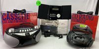 Set of Proscan audio equipment including two black CD radio boomboxes with cassette players, AM/FM radios, and a Bluetooth CD micro system with remote and manual.
