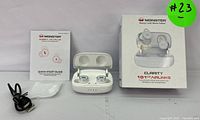 Monster Clarity 101 Plus wireless earbuds in open charging case, with box, quick start guide, and charging cable displayed.
