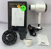 Wavytalk hair dryer with all attachments laid out alongside the box and user manual.
