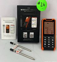 Wireless smart meat thermometer device, two probes, instruction manual, and box are shown.