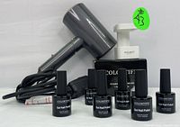 Photo showing the dark gray professional hair dryer and six bottles of ColorTific gel nail polish in black bottles with a box and nozzle attachment