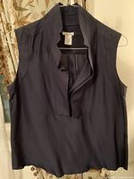 Front view of vintage Oscar de la Renta sleeveless silk blouse in dark navy, showing the design, neckline, and fabric.