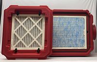 Air scrubber unit opened to show white pleated filter