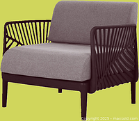 Image of the assembled Patio Flare outdoor lounge chair with light brown cushions and a sturdy black frame with open pattern sides and back.