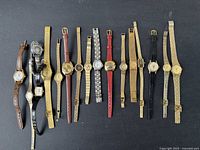 Overall view of 12 assorted women's vintage wristwatches with various metal and leather bands