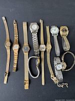 Overview photo of eleven women's vintage wristwatches with various metal bands and watch face shapes.