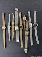 Lot of nine assorted vintage women's wristwatches with metal mesh or link bracelets in various metal tones and shapes.