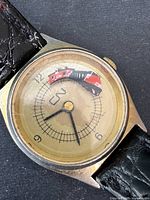 Close-up front view of the watch face showing the CN Rail train model moving around the dial, black hour markings, and hands.