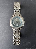 Front view of the silver tone Seiko women's wristwatch showing the linked band and watch face.