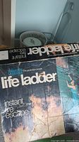 Box of metal life ladder showing branding and use as an instant fire escape