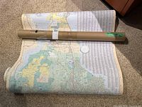 Rolled and unrolled view of one large area map showing parts of Victoria and Westshore with cardboard tube included for storage or shipping.