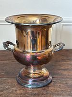 Front view of tarnished silver plated champagne bucket showing reflective surface and flared rim