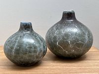 Photo of the pair of art glass vases showing size difference and crackled grey glass pattern.