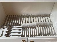 Full layout showing knives, spoons, forks and serving pieces