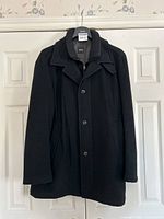 Full front view of coat hanging on door