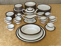 Front view of entire dinnerware set arranged on table.