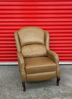 Front three-quarter view of tan leather recliner chair