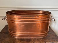 Front view of oval copper wash tub showing ribbed sides and rolled rim