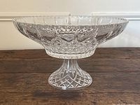 Side profile view of the clear crystal glass pedestal bowl showing the cut glass design and pedestal base.