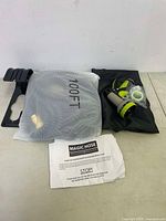 Full lot showing the 100 ft Magic Hose in packaging, sprayer nozzle, accessories, and instruction sheet.