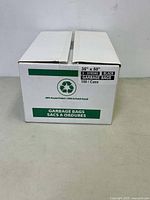 Front and top view of a white cardboard box labeled "Garbage Bags" with product size 35" x 50", black, x-strong, with 100 bags per case