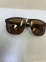 Front angled view showing the left lens Ray-Ban P logo and brown tortoise acetate frame.