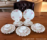 Full view of all 25 pieces arranged in five place settings: dinner plate, luncheon plate, bread plate, cup and saucer